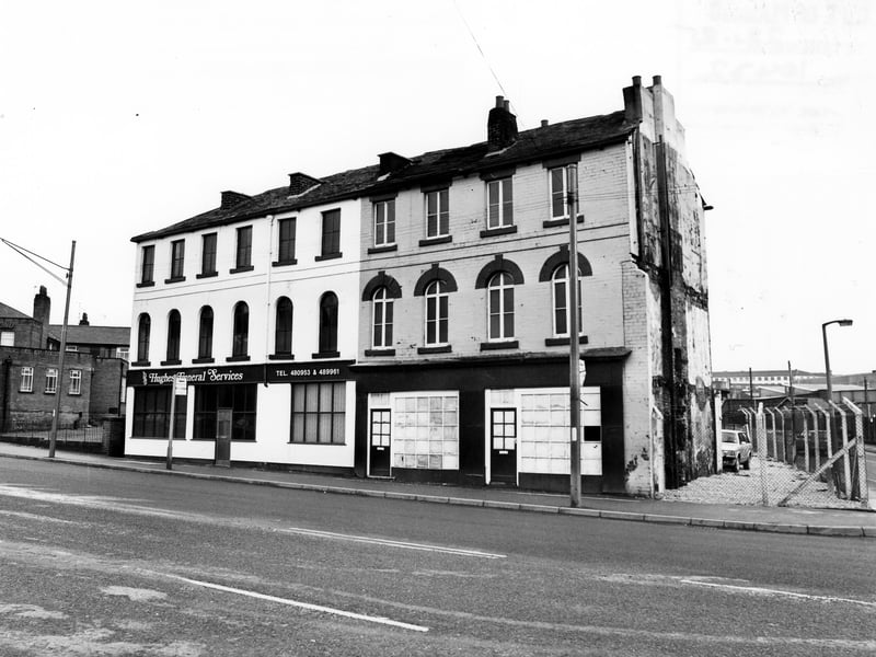 The east side of Marsh Lane showing Hughes Funeral Services . On the left is the Woodpecker public house and on the right the junction with Shannon Street. Pictured in January 1985.