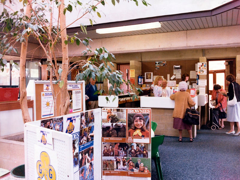 Inside Horsforth Branch Library on Town Street in June 1985. This shows the adult lending section situated in the extension to the building opened in 1975. A display celebrating the 75th anniversary of the Girl Guide Association is seen in the foreground while the counter area is in the background.