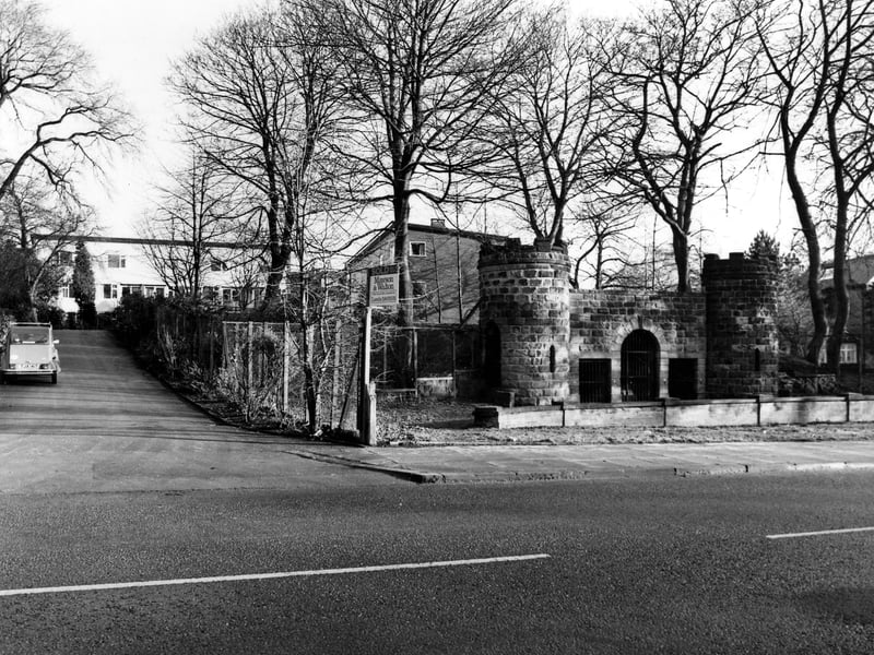 The Victorian Bear Pit on Cardigan Road which was built as part of the Leeds Zoological and Botanical Gardens opening in 1840. The castellated turrets were safe viewing platforms for visitors to observe the bear kept in the circular bear pit behind the wall. They were accessed by spiral staircases within the towers. The gardens were re-named Leeds Royal Gardens in 1848. To the left the road is Regency Court leading to flats. Pictured in January 1985.