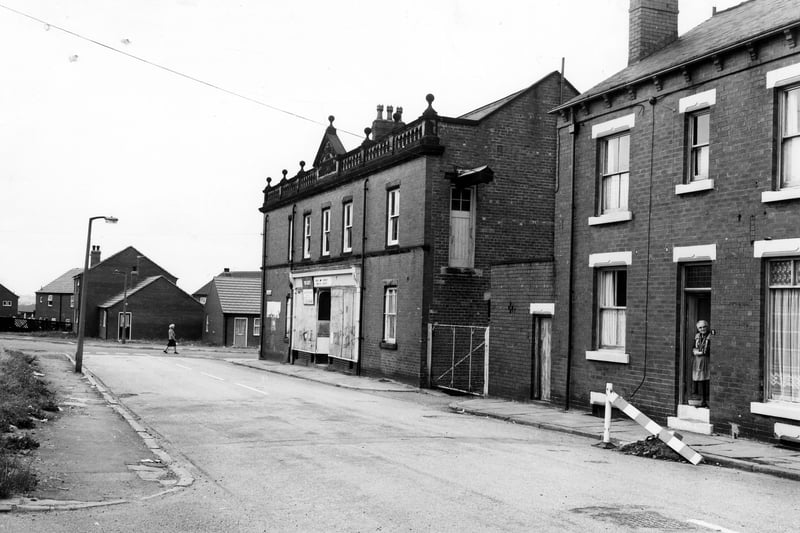Hardy Street looking towards Lodge Lane. In the foreground, left, is the junction with Tempest Place and waste land where Ellis Place once stood. In the centre the former Leeds Industrial Co-operative Society building can be seen at number 1 Hardy Street, with decorative gable and roof line.  Pictured in August 1983.