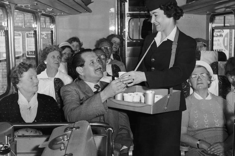 Denise George serving refreshments to passengers on board a 'Gay Hostess' luxury coach service between London, Blackpool and the Lake District, 31st May 1960