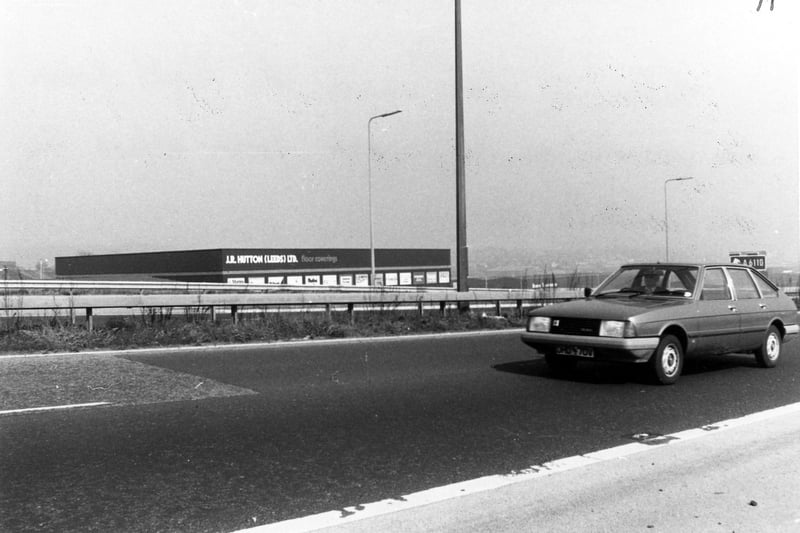 The M621 motorway showing the warehouse of J.R. Hutton Ltd, floor coverings, on Beeston Royds Trading Estate. Pictured in May 1981 .