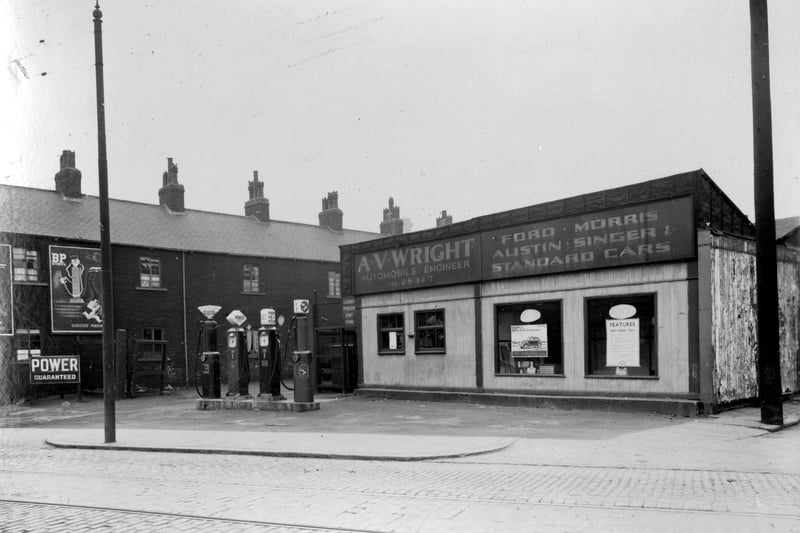 AV Wright motor engineers which was at no 11 Armley Road between Douro Street and Neill Street. Shows road leading up to workshop with petrol forecourt to front. Pictured in April 1937.