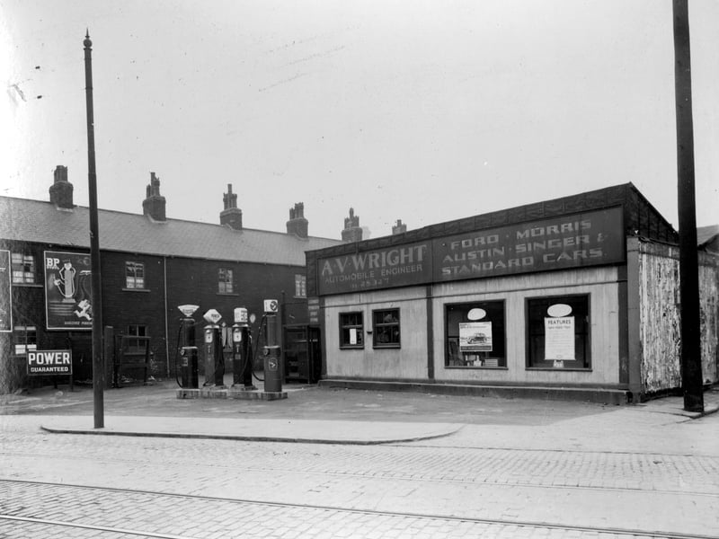 AV Wright motor engineers which was at no 11 Armley Road between Douro Street and Neill Street. Shows road leading up to workshop with petrol forecourt to front. Pictured in April 1937.