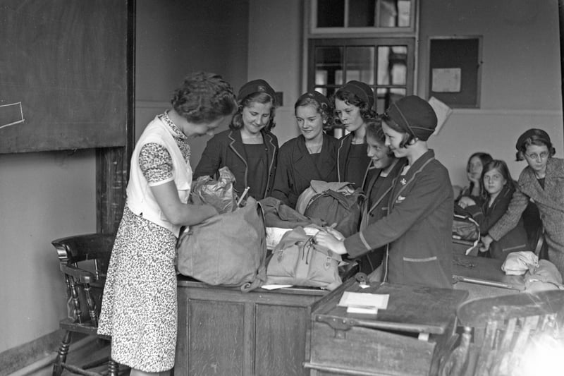 A mistress at Bede School examines pupils' kit at the evacuation rehearsal in 1939.
