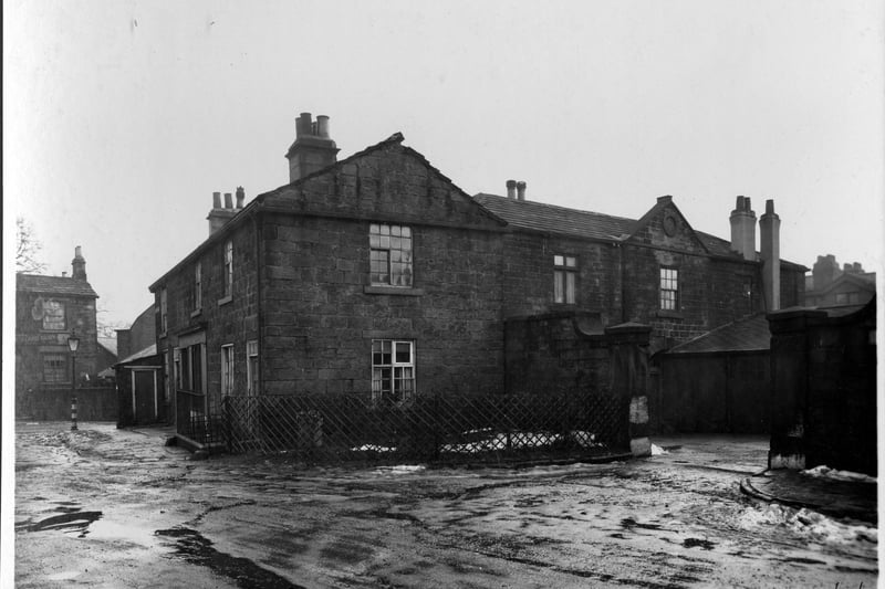 Stone cottages on Regent Street on right, through gate way, detached residence, Hawthorn House. To the left, number 64 Woodland Lane, Smith and Sowden, dairy. This building is now numbered 68 and is not to be confused with Alcuin School, numbered at 64 until its closure in July 2009, and located in the former St. Matthew's Church Hall next door. Pictured in February 1940.
