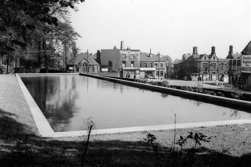 Completed static water supply basin, constructed in the grounds of Allerton House, Allerton and Oakwood Lawn Tennis Club as a wartime measure. Situated on the corner of Stainbeck Lane the photograph looks across Harrogate Road to the Wesleyan Methodist Church and Hall, Stephenson's Butchers, Thrift Stores, and The Midland Bank, the Police Station, Public Library and Town Street towards the Nags Head. Pictured in September 1942.