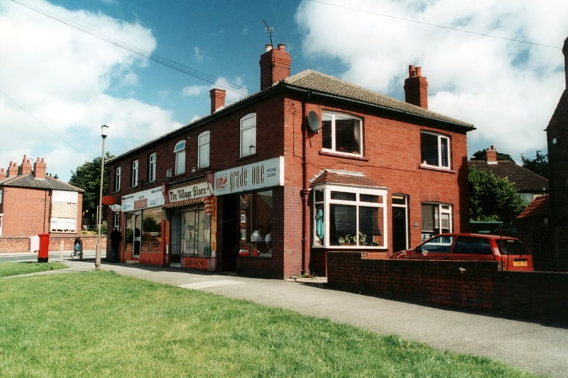 A parade of shops on Pinfold Lane in September 2000. The shops, from left, are Halton Post office, the Village Store and Grade One hair studio. The end of the parade at Grade One forms the side of the studio and the end of the house. At the other end of the parade is a letter box, beyond this is Cross Green Lane.