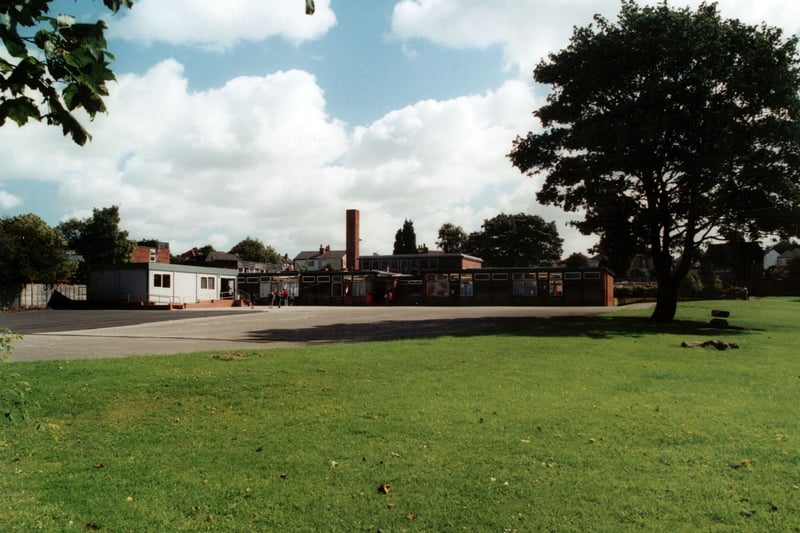 Templenewsam Halton Primary School, looking across the fields and playground from Chapel Street. A few children can be seen in front of the predominantly one storey building and annexe. Pictured in September 2000.