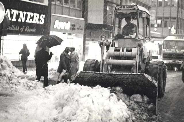 A strange sight for Blackpool as a bulldozer clears a path for cars in the town centre, 1981