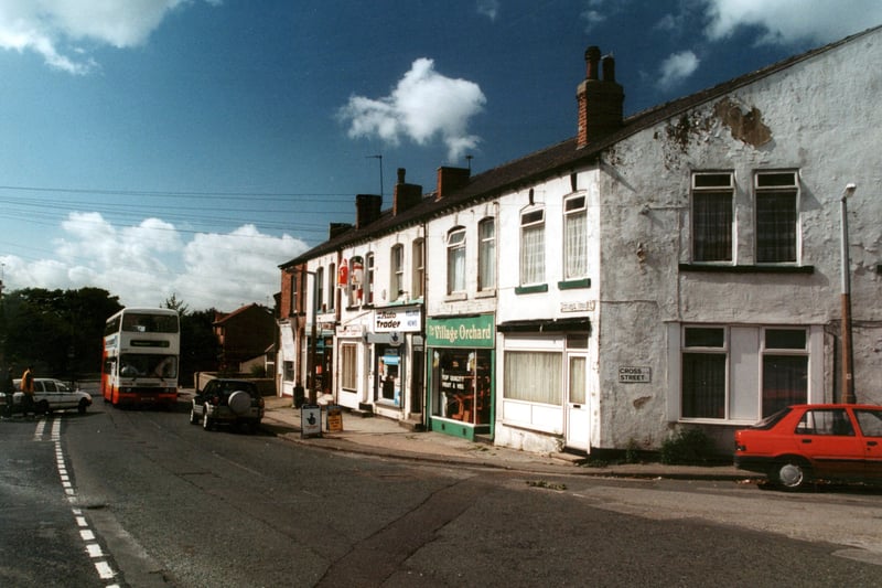  Looking west across Chapel Street at small parade of shops and junction with Cross Street. Visible at the right end of the parade are Village News, The Village Orchard, greengrocers, the last shops having become a private dwelling. Pictured in September 2000.