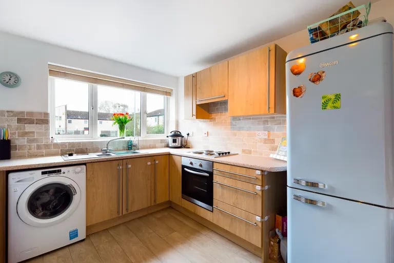 The generously sized kitchen with a range of matching fitted wall and base units.