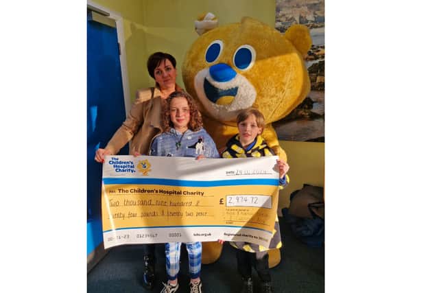 Alfie and Nancy Exelby with mum Sarah and Theo the Bear at the cheque presentation at Bradway Primary School on January 24, 2024.