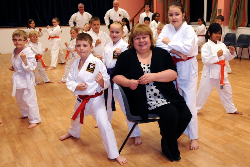 Karen Maclennan from Grace House with Deptford and Millfield Community Centre karate club members who  raised thousands of pounds for the charity in 2011.