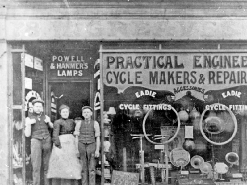 Greaves cycle shop, on Middlewood Road, Hillsborough, some time between 1900 and 1919. Joseph Greaves (left) is pictured with his mother Selina in the shop doorway. The small boy peeping between the shoulders is William Bradshaw Greaves.