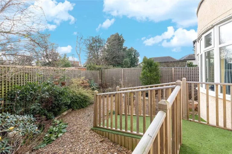 The spacious home sits on a large corner plot with surrounding gardens.