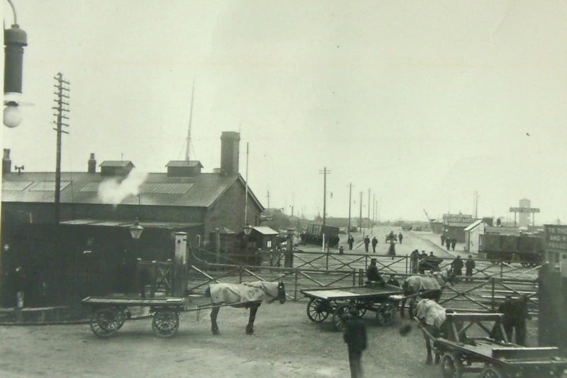 Carts wait for the level crossing gate to open at the entrance to Fleetwood Dock. The area is now Mariners Quay, Anchorage Way and Home Bargains