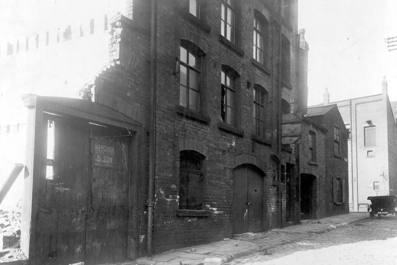 Virginia Street Mills and Forge pictured in September 1928. The demolition of the mill is taking place. The gates on the left have sign for Mencher and Son rag merchants who had operated a business from here. On the right Cross Virginia Street can be seen.