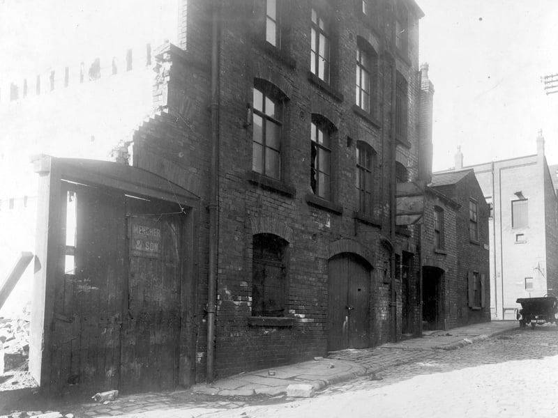 Virginia Street Mills and Forge pictured in September 1928. The demolition of the mill is taking place. The gates on the left have sign for Mencher and Son rag merchants who had operated a business from here. On the right Cross Virginia Street can be seen.