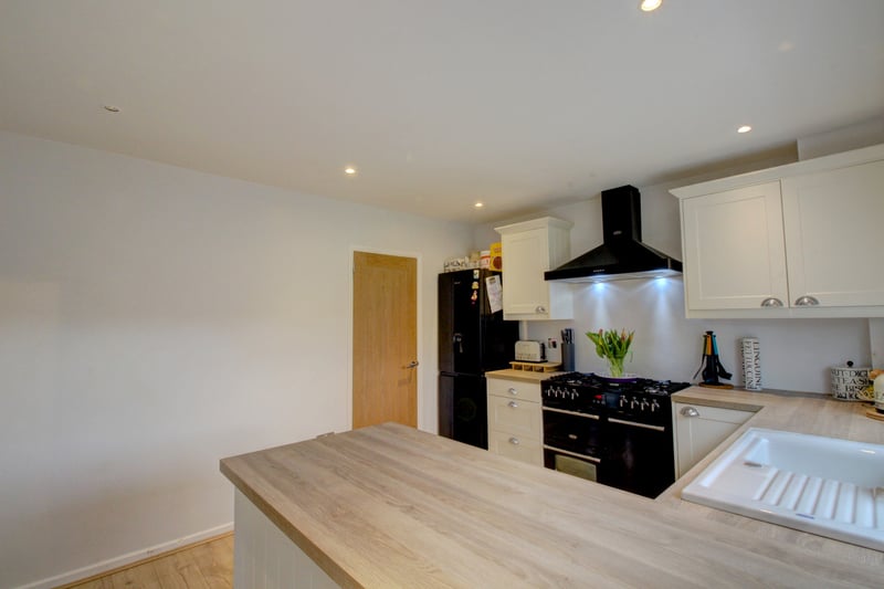 The newly refurbished kitchen offers a range of fitted base and wall mounted shaker style units.