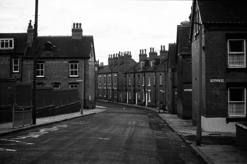 Cross Quarry Street looking east. Junctions with Thomas Street, Quarry Place, Quarry Street and Christopher Road are on the right before the road becomes Glossop Street as it bears towards the left. On the far left, a fence encloses the grounds of Quarry Mount Primary School, followed by the junction with Quarry Street. Pictured in August 1985.