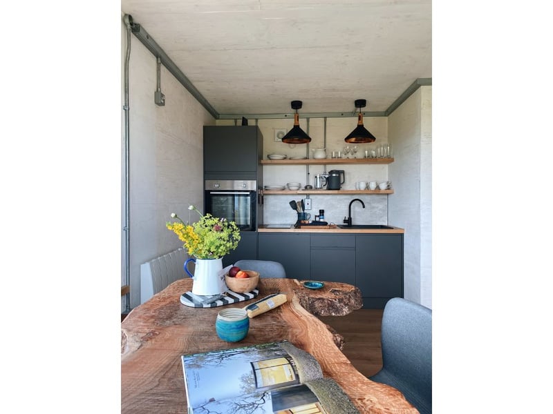 The kitchen features a quirky handmade oak dining table.