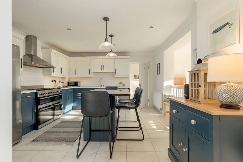 Also part of the extension is this well-equipped contemporary kitchen has an island unit, range cooker, fridge/freezer and dishwasher, with the washing machine and tumble drier housed in the utility room. 