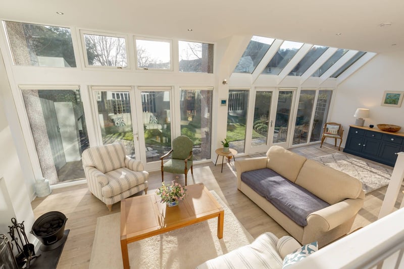 The extension was designed by the celebrated Edinburgh architect Richard Hall and provides direct access to the garden via glazed doors. This area is the hub of the home and includes this delightful family room/second sitting room.