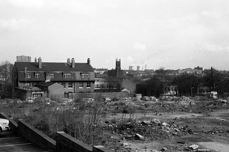 A view taken from the car park of the Hobby Horse public house on Lovell Park Road in 1970. Waste ground beside the car park has since been redeveloped with new housing. The block of houses to the left still exists on Lovell Park Hill but is now surrounded by new buildings. A tower block visible behind is possibly Naseby Grange. In the centre background is St. Mary’s Church, Mabgate, while to the right the view looks towards Quarry Hill Flats and Saxton Gardens.