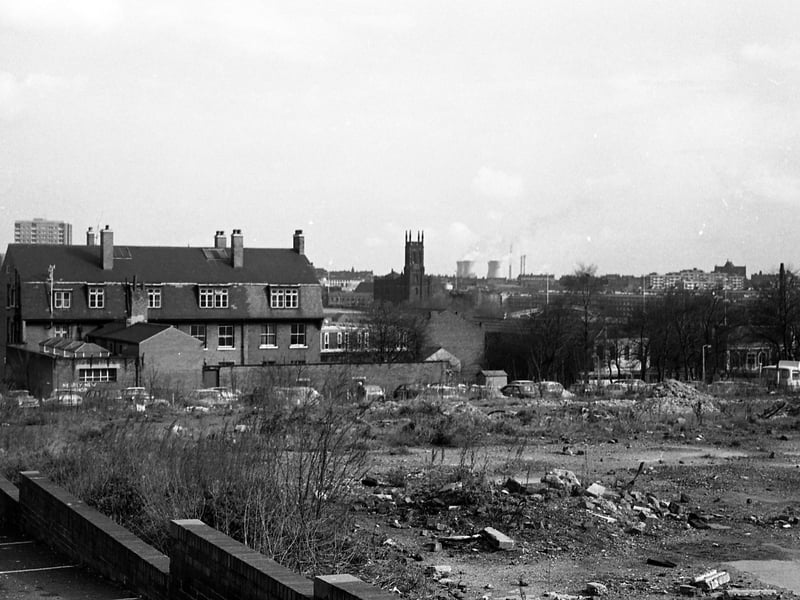 A view taken from the car park of the Hobby Horse public house on Lovell Park Road in 1970. Waste ground beside the car park has since been redeveloped with new housing. The block of houses to the left still exists on Lovell Park Hill but is now surrounded by new buildings. A tower block visible behind is possibly Naseby Grange. In the centre background is St. Mary’s Church, Mabgate, while to the right the view looks towards Quarry Hill Flats and Saxton Gardens.