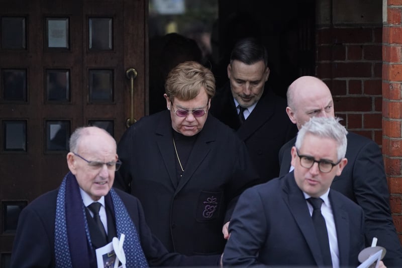 Sir Elton John and David Furnish leaving the funeral service of Derek Draper.