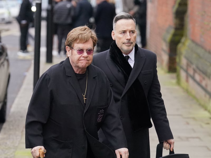 Sir Elton John and his partner David Furnish  attending the funeral service of Derek Draper