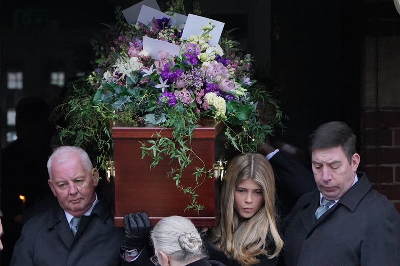 Pall bearers, including Derek and Kate's daughter Darcey carry the coffin