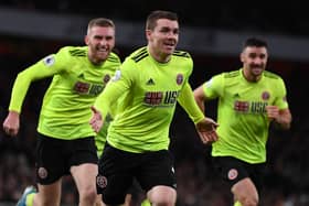 John Fleck (C) celebrates after scoring the equalising goal during the English Premier League football match between Arsenal and Sheffield United at the Emirates Stadium in London on January 18, 2020