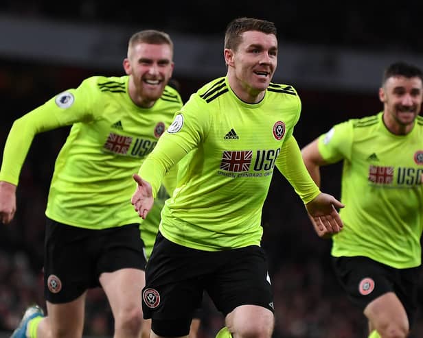 John Fleck (C) celebrates after scoring the equalising goal during the English Premier League football match between Arsenal and Sheffield United at the Emirates Stadium in London on January 18, 2020