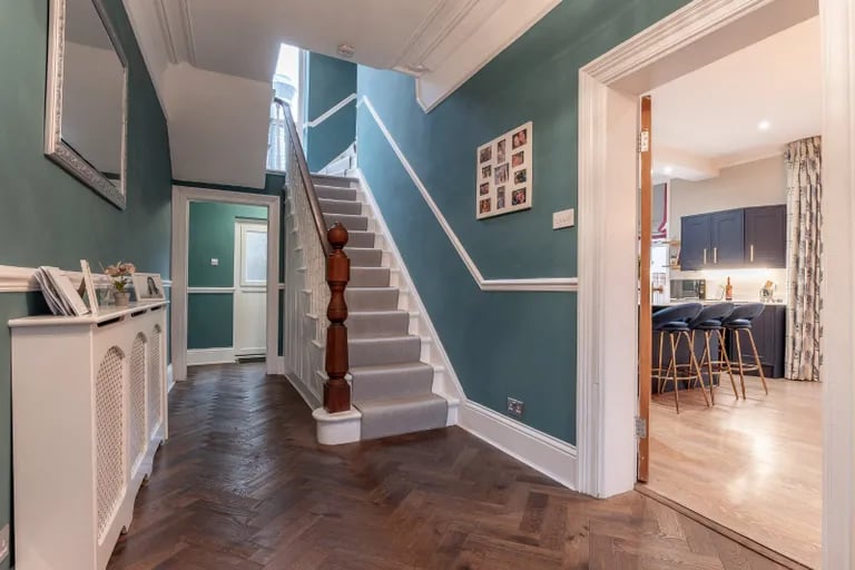 Enter into this beautiful hallway with stairs to the first floor.