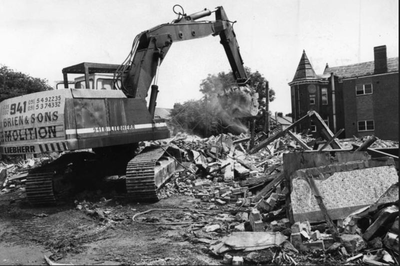 A digger clears another load of bricks and mortar away from the Ingham Infirmary in June 1991.