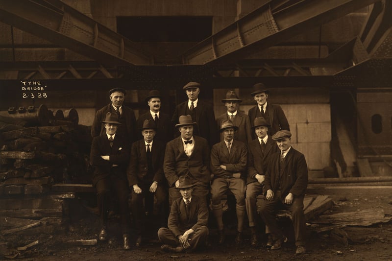 Construction staff of the Tyne bridge, employed by Dorman Long & Co. Ltd, 2 March 1928 .

Standing left to right: J. Morgan (Foreman Mason), W. Kingston (Cashier), K. Addison (General Foreman), F. Conaron (Chief Timekeeper), F. Atkinson (Chief Storekeeper). 

Seated left to right: O.T.R. Leishman (Engineer 2), J. Geddie (Chief Assistant), J. Ruck (Agent), G.I.B. Gowring (Engineer 1), E.W.C. Symes (Engineer 3), W. Pattison (Foremen Carpenter).

 Seated on ground: F.D.S. Sandeman (Junior).