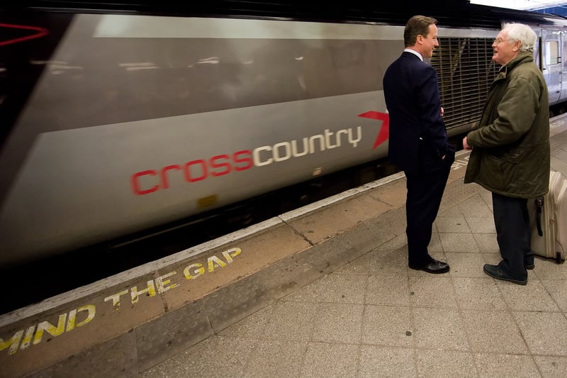 British Opposition Conservative Party leader David Cameron (L) speaks to a member of the public as he waits for a train at Birmingham New Street rail station on April 6, 2010 in Birmingham, England. 
