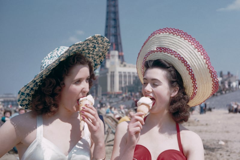 Two girls enjoy ice creams on the sands at Blackpool, July 1954. Blackpool Tower can be seen in the background. Original publication: Picture Post - 7227 - Blackpool - pub. 31st July 1954 (Photo by John Chillingworth/Picture Post/Hulton Archive/Getty Images)