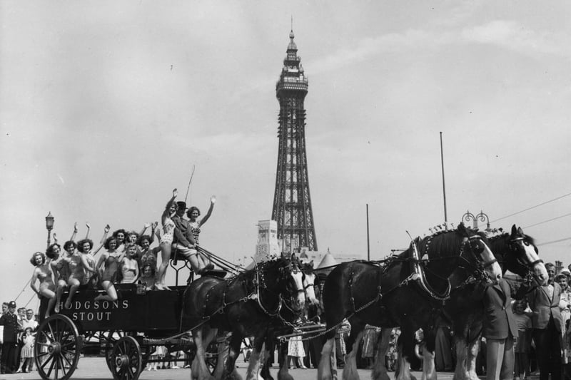 3rd July 1953:  A group of bathers getting a lift on a dray pulled by four of London Brewery's Clydesdale Shire horses who have arrived in Blackpool for the Royal Show.  (Photo by Fox Photos/Getty Images)