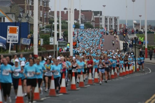 A sea of blue as the runners head along the coastline.