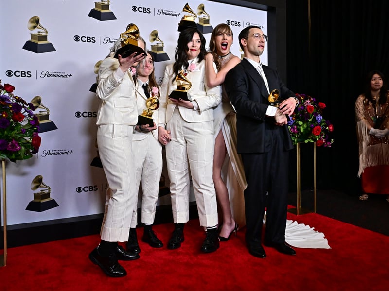 Taylor Swift winner of Best Pop Vocal Album and Album of the Year for "Midnights" poses with Julien Baker, Phoebe Bridgers, Lucy Dacus of US indie group boygenius holding the Grammy Awards for Best Alternative Music Album for "The Record", Best Rock Song for "Not Strong Enough" and Best Rock Performance for "Not Strong Enough" with singer and producer Jack Antonoff during the 66th Annual Grammy Awards. 