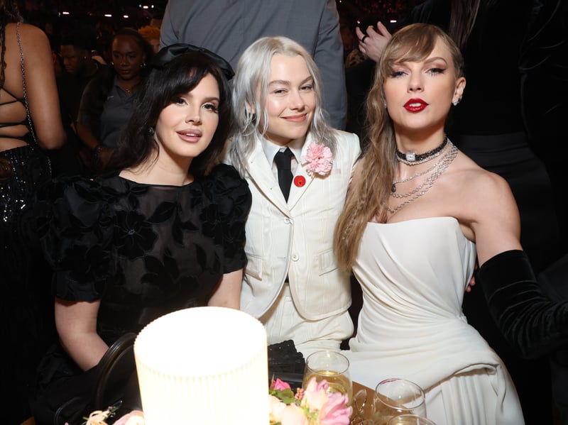 Lana Del Ray, Phoebe Bridgers and Taylor Swift sit together at the Grammys