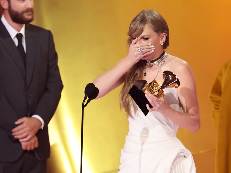 Taylor Swift accepts the "Album Of The Year" award for "Midnights" onstage, making history. Image: Getty