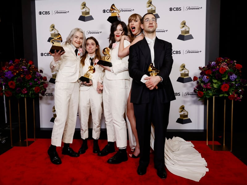 Phoebe Bridgers, Julien Baker, and Lucy Dacus of Boygenius, pose with their Grammy Awards alongside Taylor Swift and Jack Antonoff. 