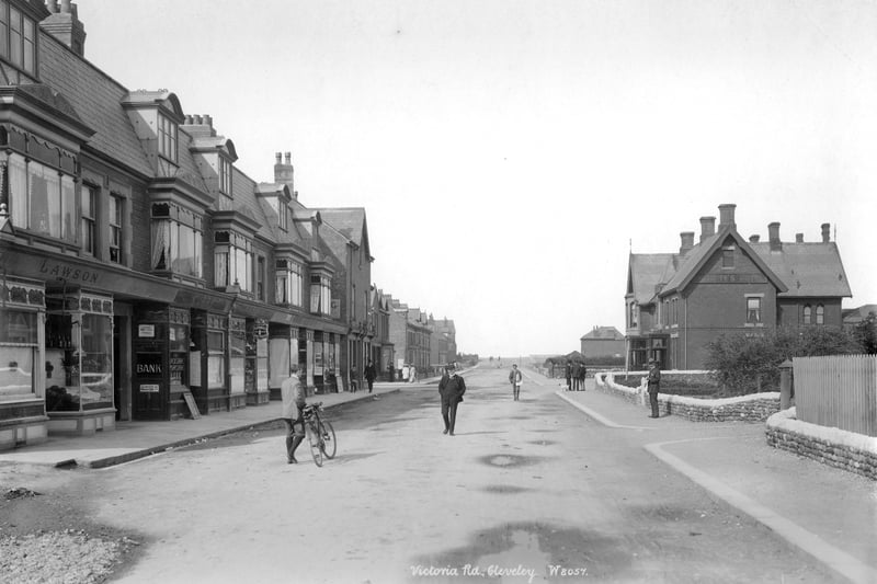 Victoria Road, Cleveleys, Lancashire, 1890-1910. A street view of Cleveleys looking west with shops and a bank to the left of the photograph and people on the road (including a man with a bike). (Photo by English Heritage/Heritage Images/Getty Images)