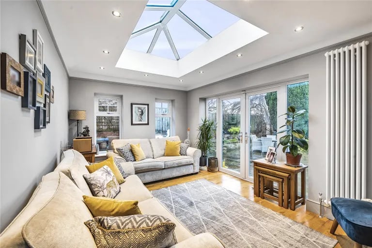 Another gorgeous sitting room with roof lantern also overlooks the large patio.