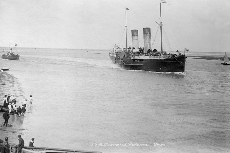 The Isle of Man paddle steamer, Fleetwood, Lancashire, 1890-1910. A group of people watch the Isle of Man paddle steamer approaching Fleetwood. The steamer is packed with passengers waiting to alight. (Photo by English Heritage/Heritage Images/Getty Images)