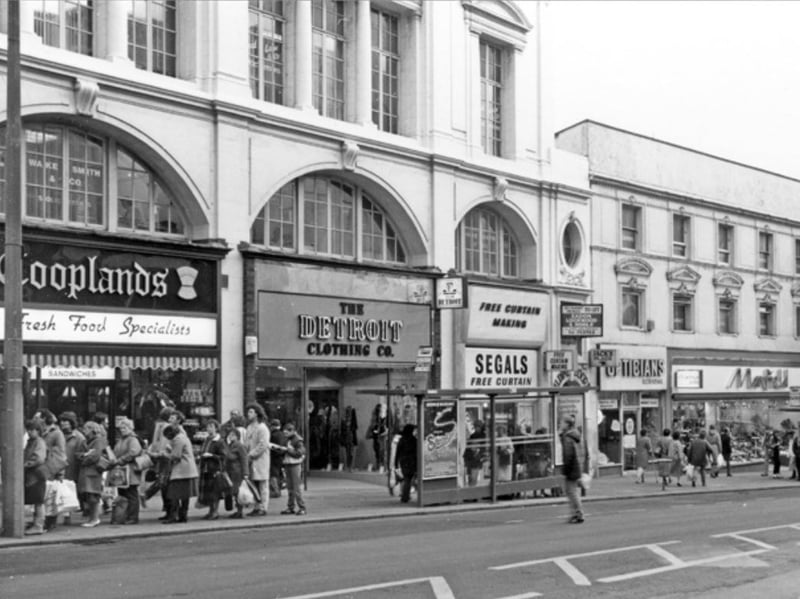 High Street, Sheffield city centre, in December 1985, showing Cooplands bakers, The Detroit Clothing Co, Segals and Sons, Scrivens opticians, and Manfield and Sons